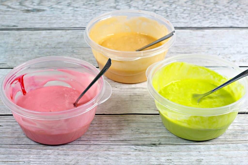 3 colors of cake batter in bowls. 