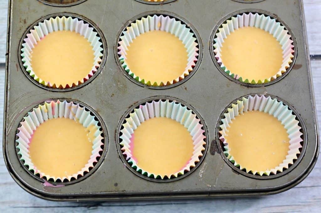 orange cake batter in cupcake tin. 