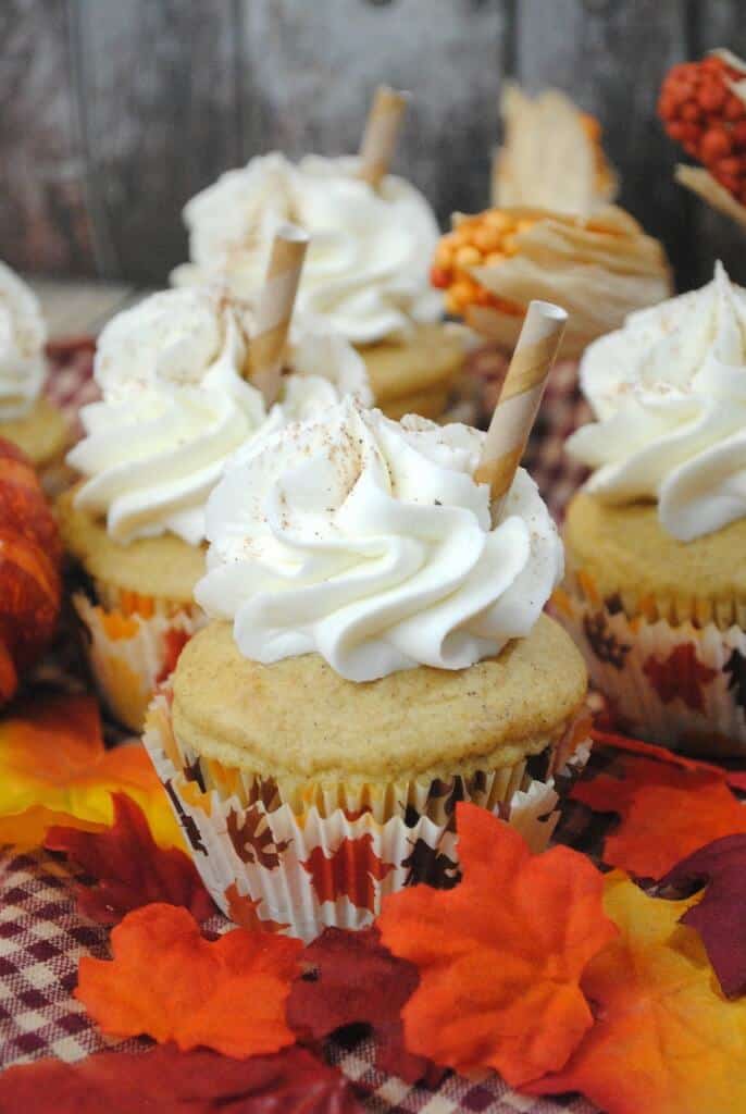 Pumpkin Spice Latte Cupcakes with Cream Cheese Frosting and a straw on top