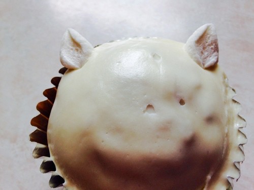 adding marshmallow halves to cupcake to create ears,