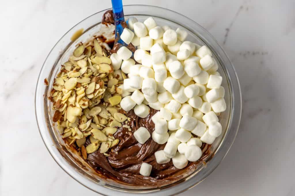 marshmallows and almonds on top of chocolate mixture