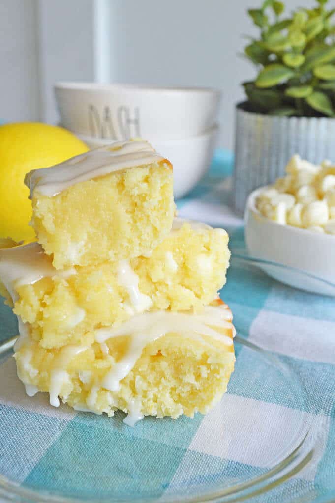 Lemon Blondies cut and stacked on a plate.