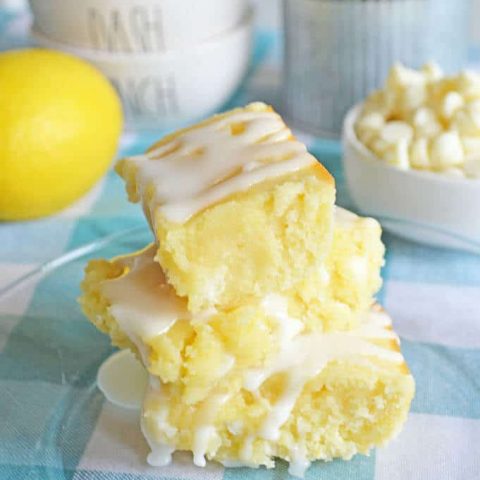Lemon Blondies Brownies with Lemon Glaze on a plate.