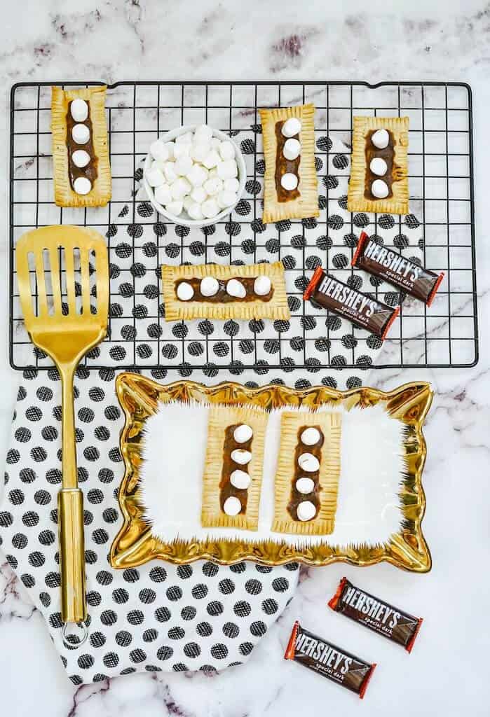 Air Fryer S’more Pop Tarts on a plate with chocolate pieces around.