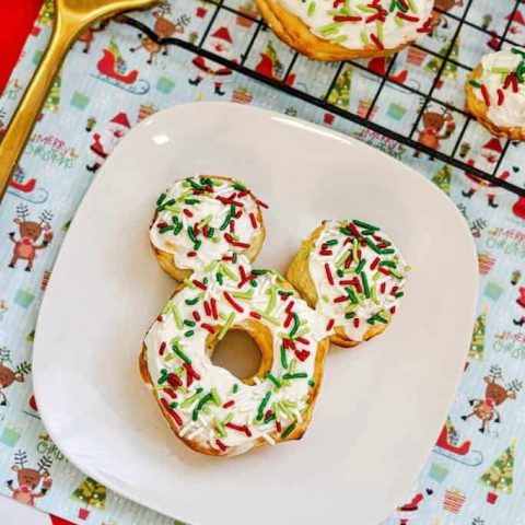3 Christmas Mickey Donuts on white plate.