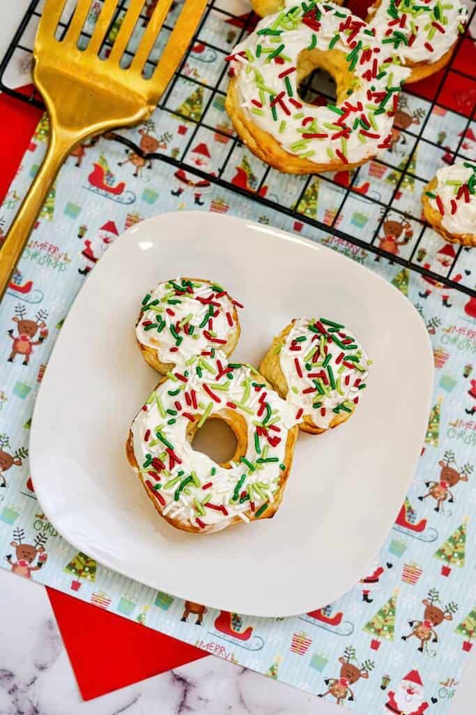 3 Christmas Mickey Donuts on white plate.