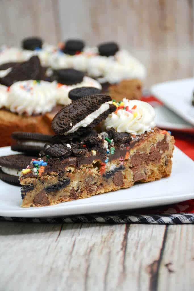 slice of Oreo Sprinkle Cake with chocolate chip cookie base. 