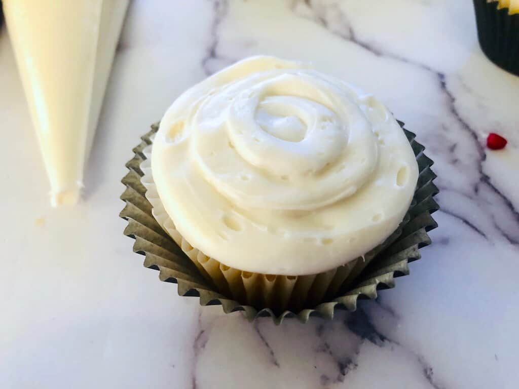 cupcake piped with white frosting.