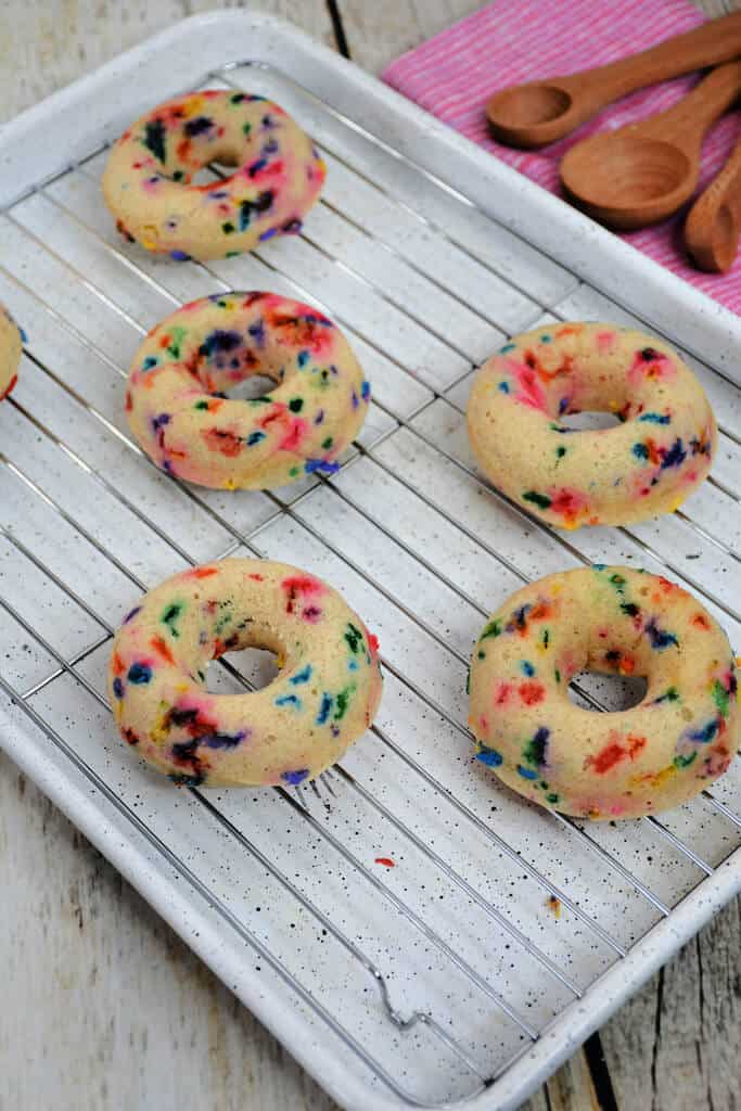 colorful donuts on a cooling rack.