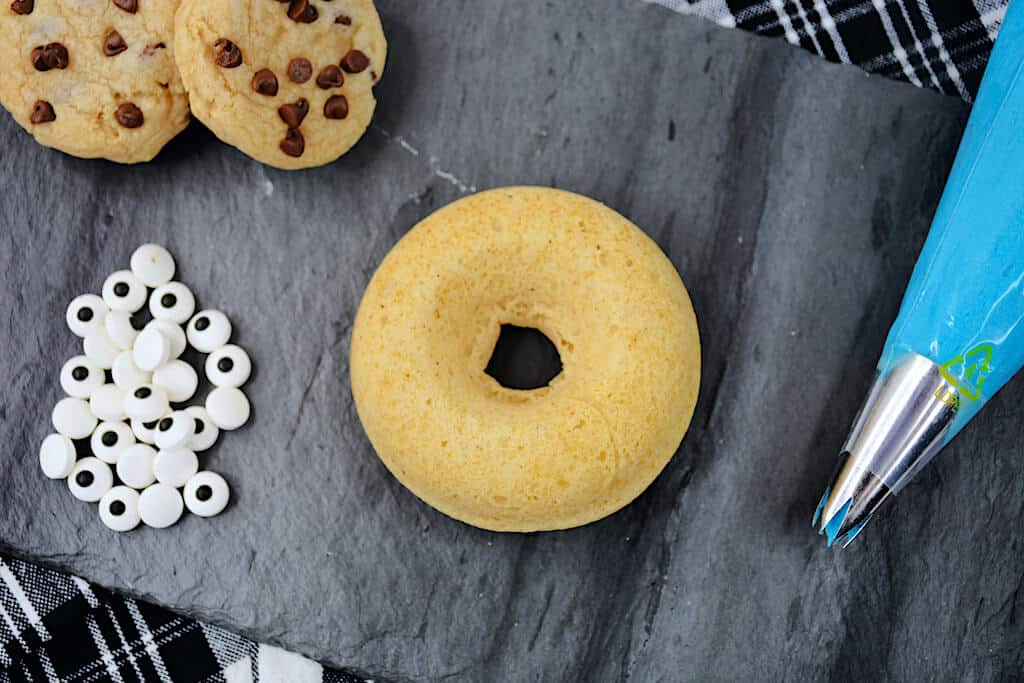 Donut with chocolate chip cookies on a gray marble.