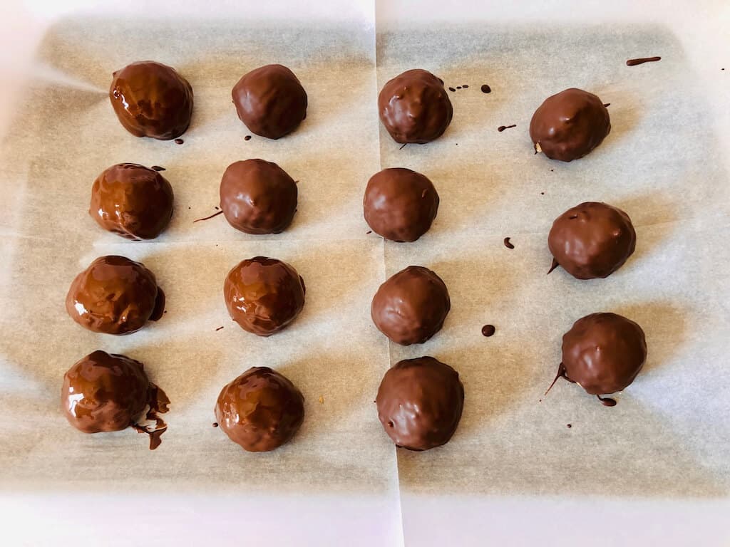 Muddy buddy truffles dipped in melted chocolate.