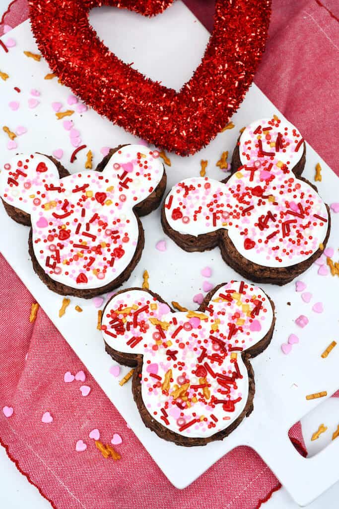 Mickey Mouse Brownies on a plate with heart sprinkles .