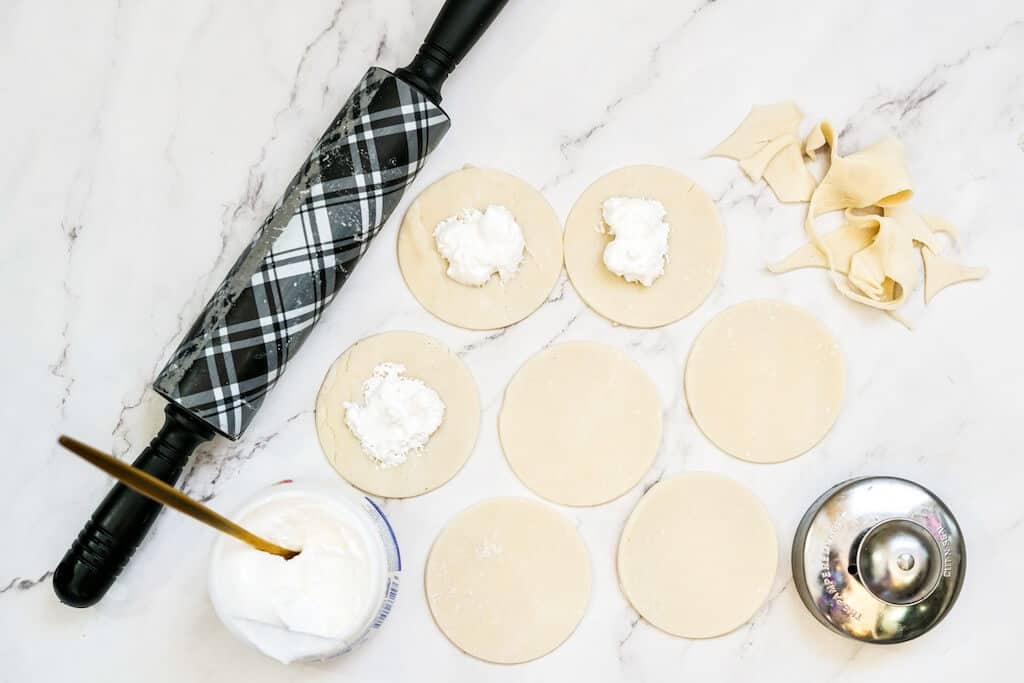 Marshmallow fluff on pie crust circles.