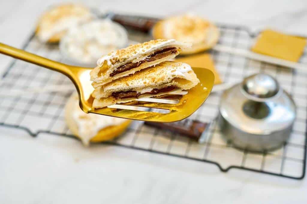 Two fried pieces of air fryer s'mores pie pops.